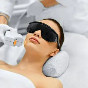 a woman receiving laser treatments
